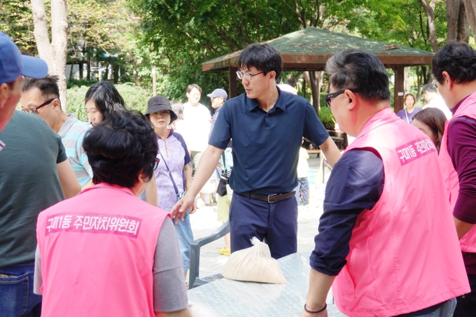 최재일 주민자치위원장(가운데)이 떡메치기를 위한 준비를 하고있다.